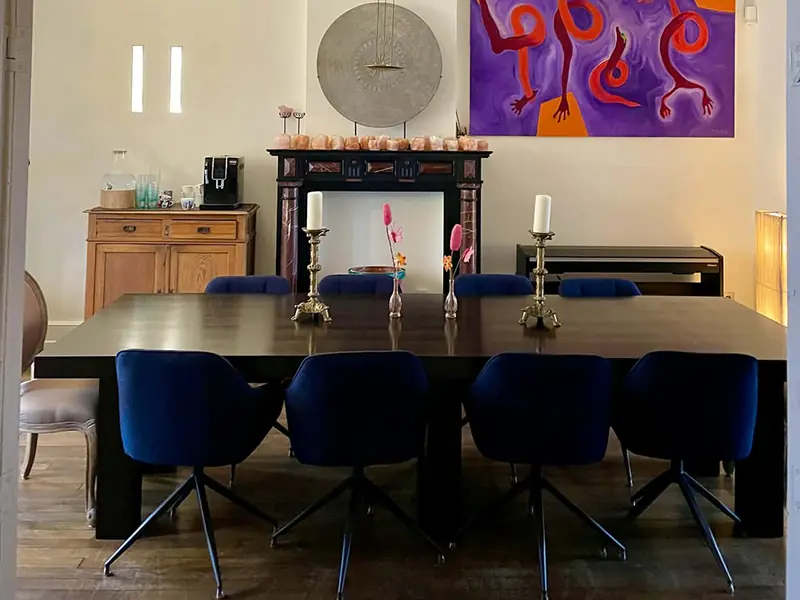 Dining room with long table and art