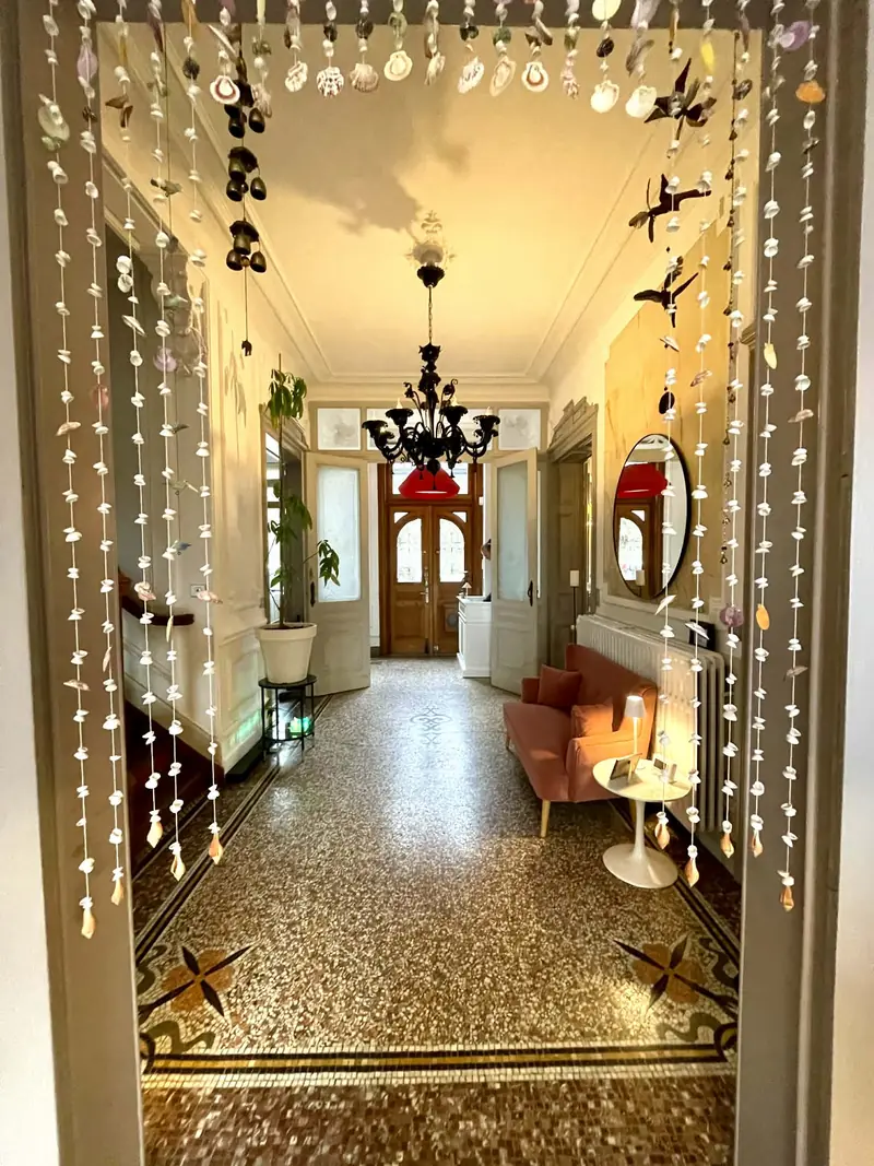 The original entrance hall with mosaic floor and chandelier
