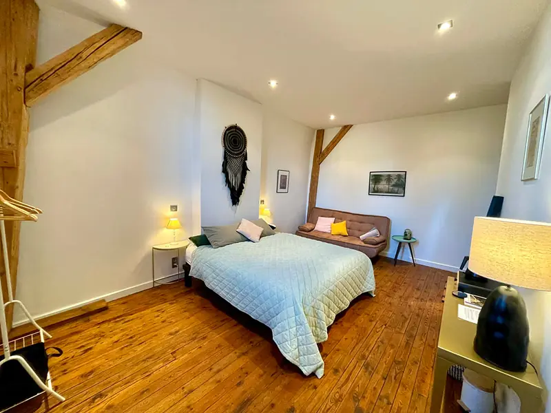 Room 3 with wooden floor and raised bed