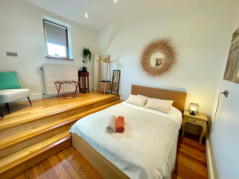 Room 5 with sunburst mirror and garden view