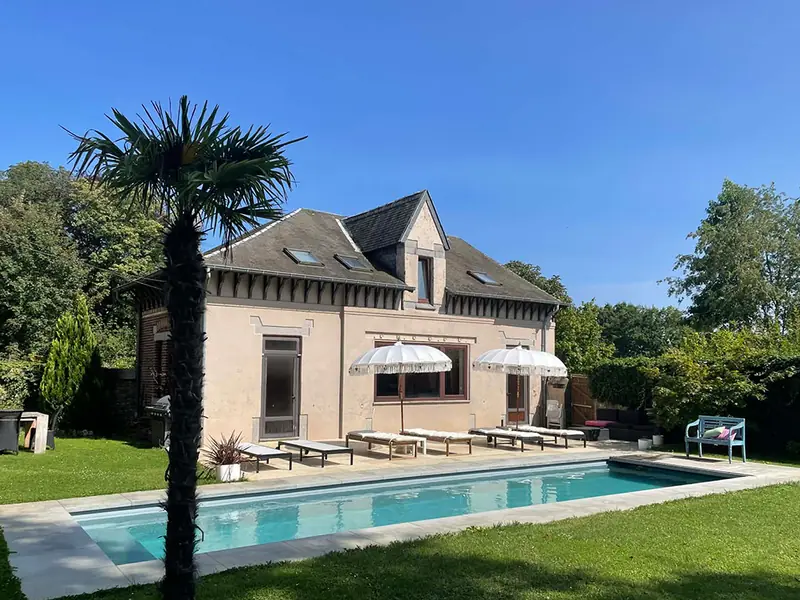 The Poolhouse with palm tree by the pool