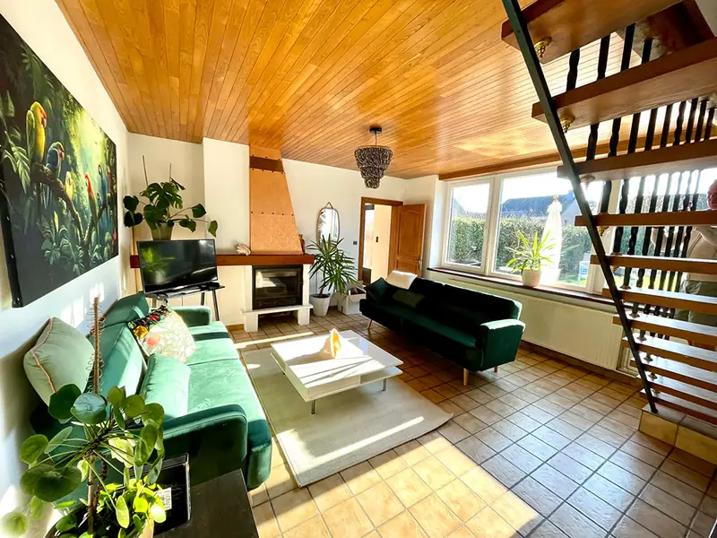 Poolhouse lounge with green sofas