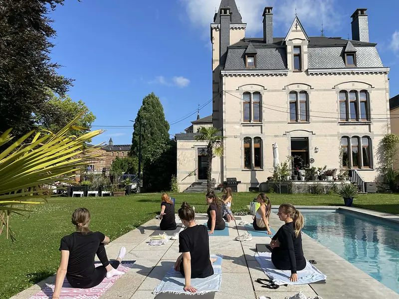 Guests doing yoga in the garden at Villa O