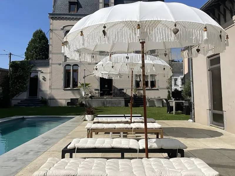 Terrace with parasols and loungers by the pool